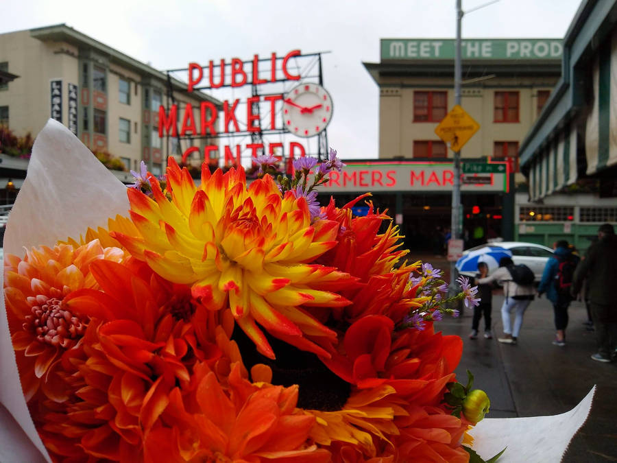 Vibrant Orange Flower Bouquet At Pike Place Market Wallpaper