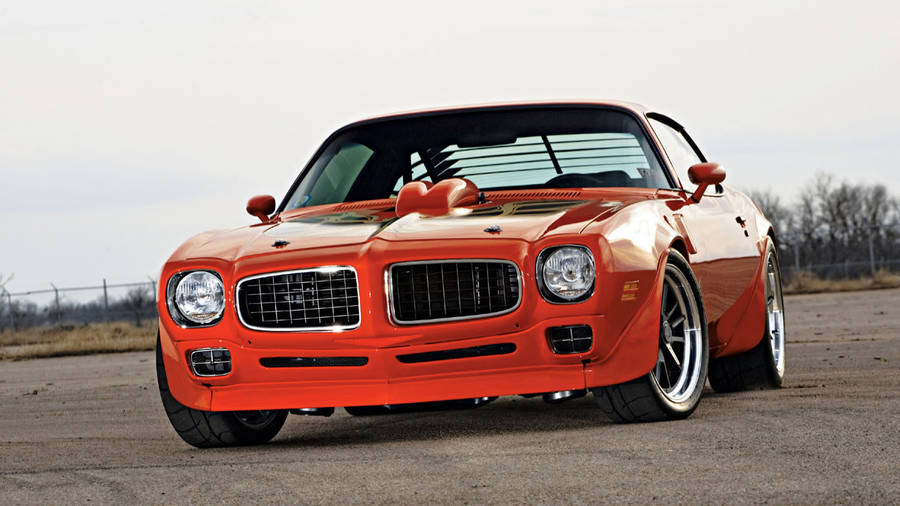 Vibrant Orange Pontiac Firebird Trans Am In Full Display Wallpaper