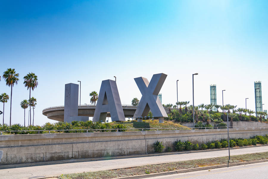 View Of Lax Signage Against A Clear Blue Sky Wallpaper