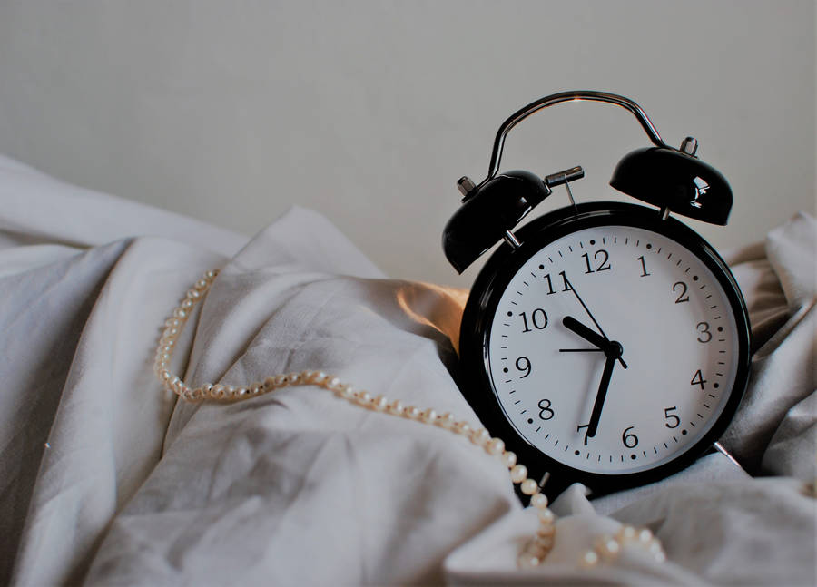 Vintage Clock On Bed Wallpaper