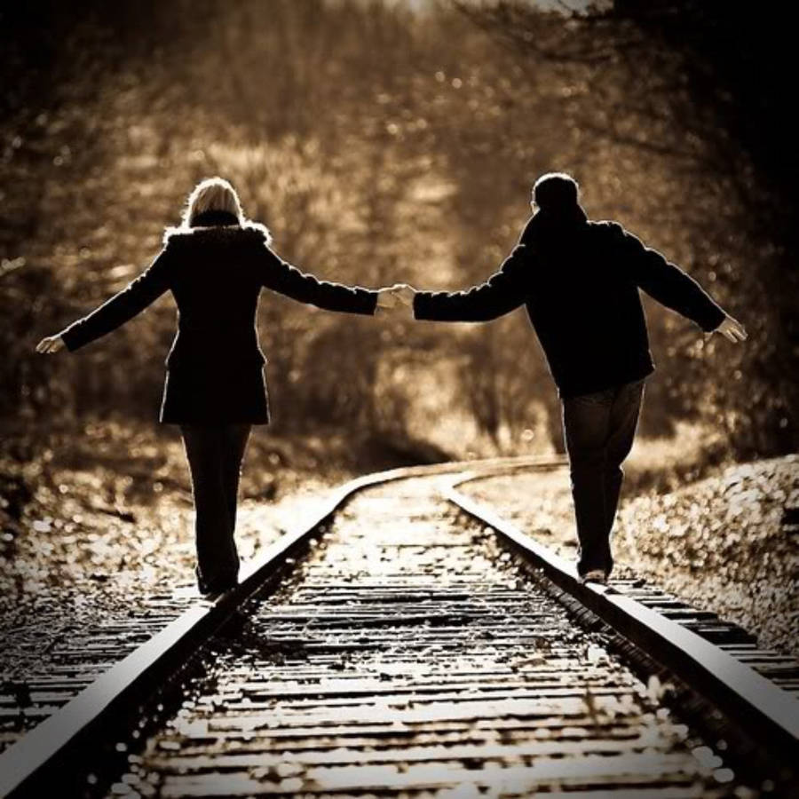 Vintage Holding Hands On The Rails Wallpaper