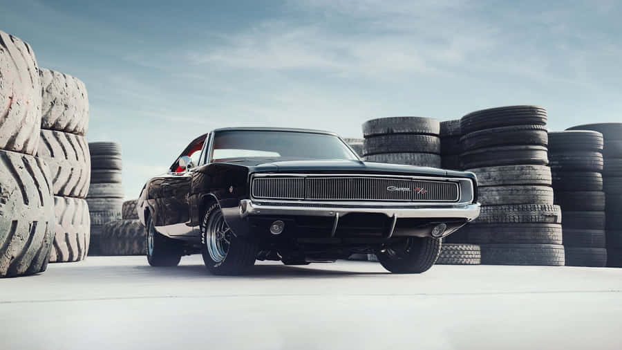 Vintage Muscle Car Beside Tires Wallpaper