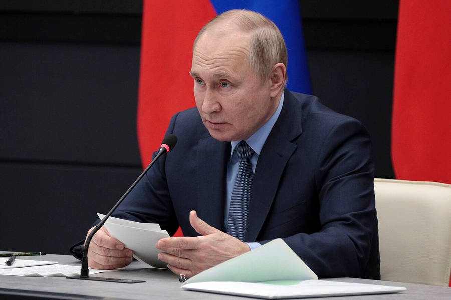 Vladimir Putin Holding Papers During Speech Wallpaper