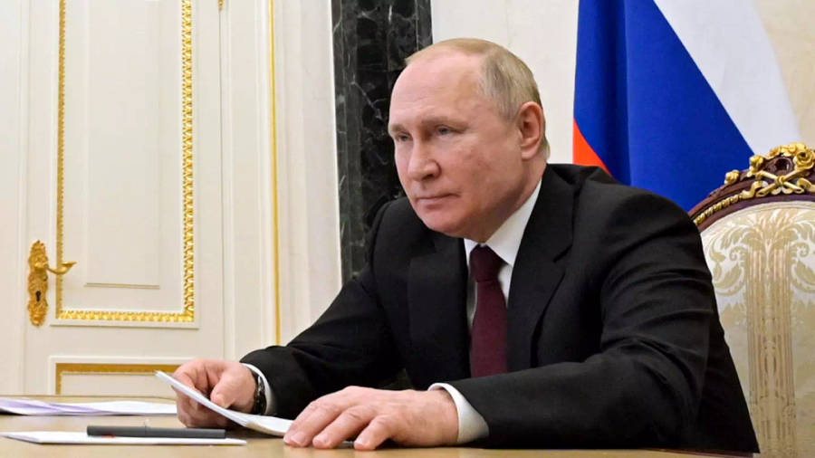 Vladimir Putin Holding Papers While Seating Wallpaper