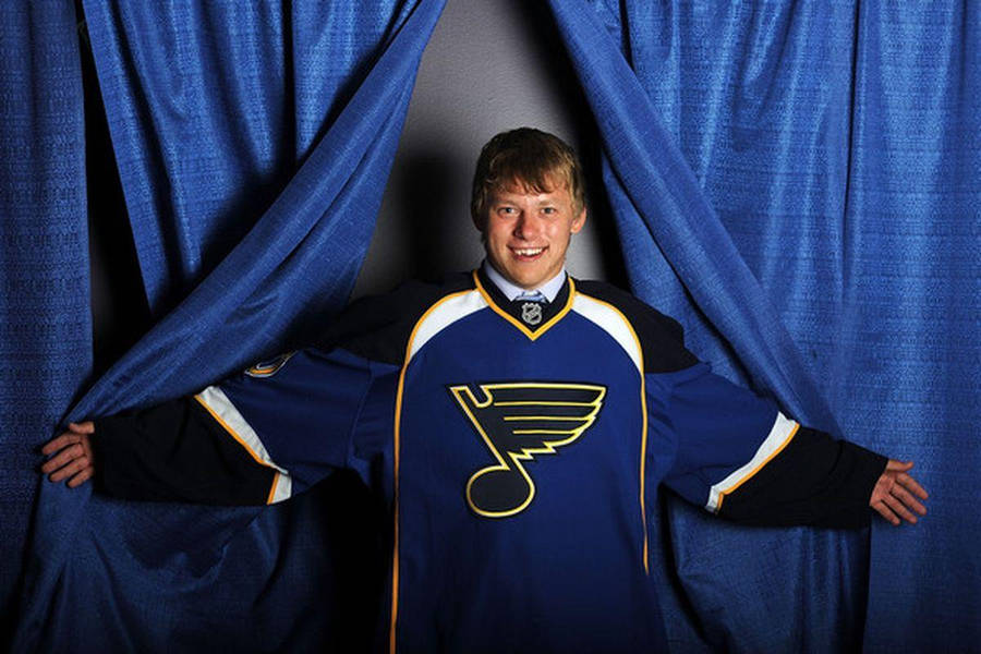 Vladimir Tarasenko Smiling With Arms Open Wearing Oversized Team Jersey Wallpaper