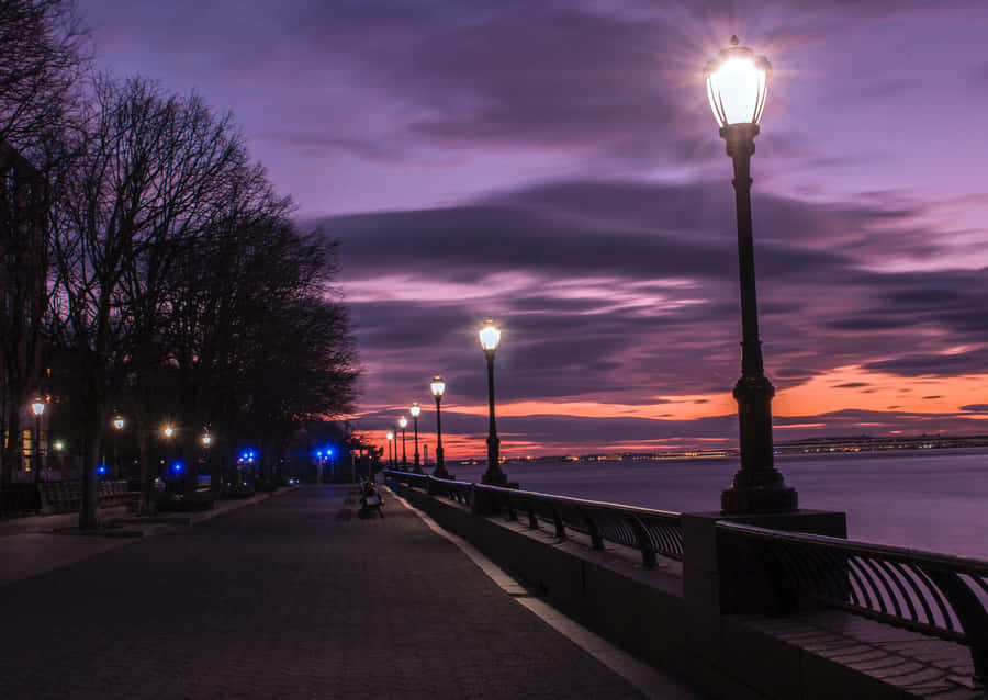 Waterfront Walkway During Evening Wallpaper