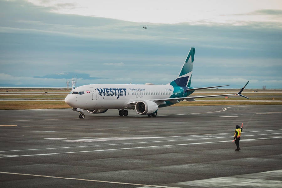 Westjet Airline Preparing To Board Wallpaper