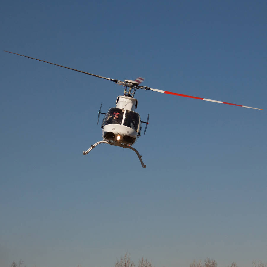 White Helicopter Tilted Flying Wallpaper