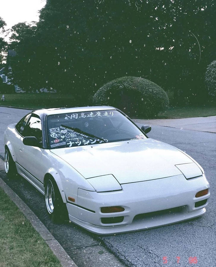 White Jdm Car Parked On Street Wallpaper