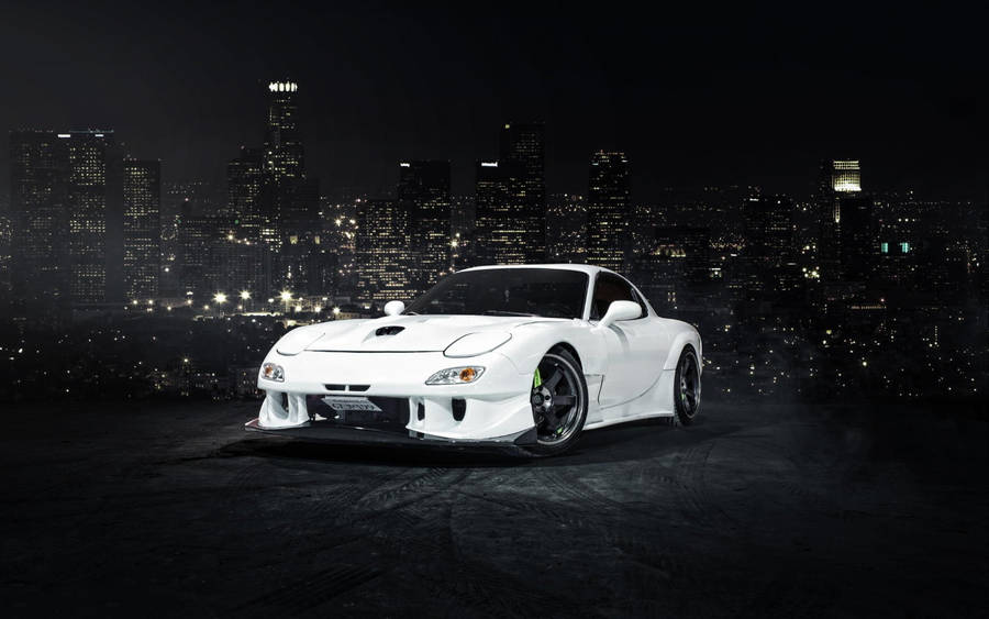 White Mazda Rx7 Overlooking City Wallpaper