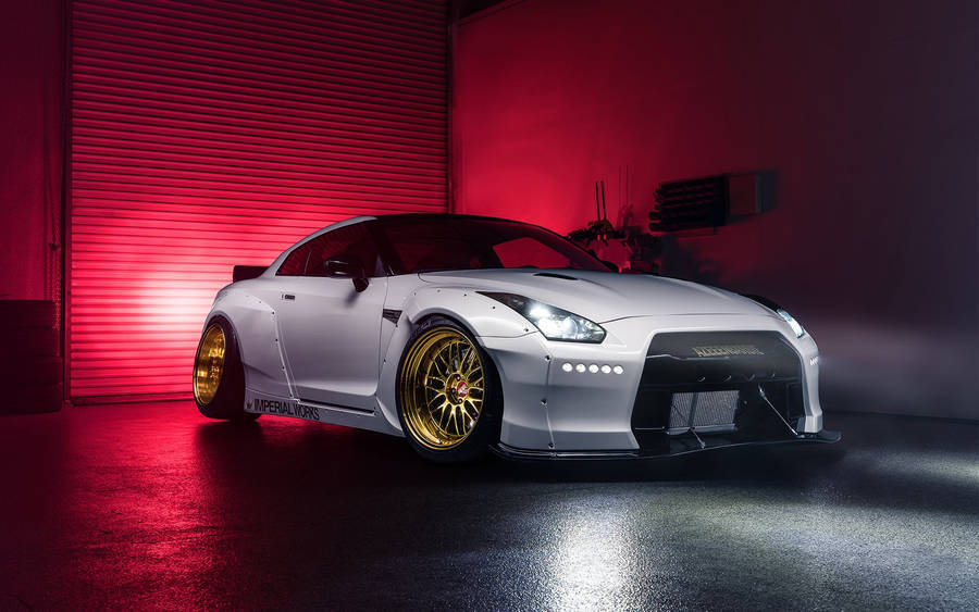 White Nissan Gtr Car With Golden Tires Wallpaper