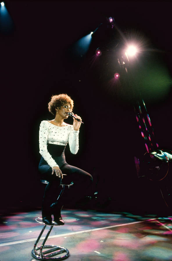 Whitney Houston Sitting On Stage Wallpaper