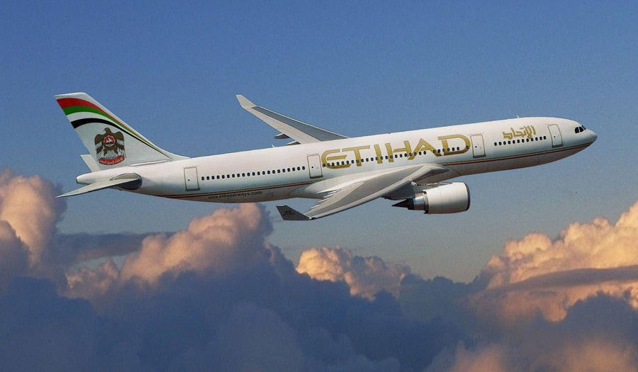 Winging Etihad Airplane With The Clouds Wallpaper