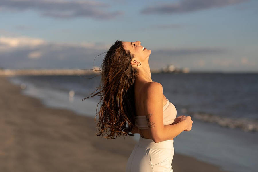 Woman Enjoying Life In The Beach Wallpaper