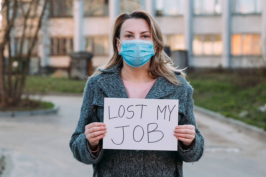 Woman Holding A Sign Of Unemployment During Pandemic Wallpaper