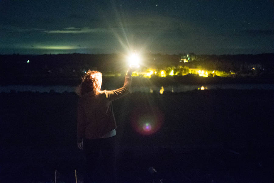 Woman Holding Lantern In Lithuania Wallpaper