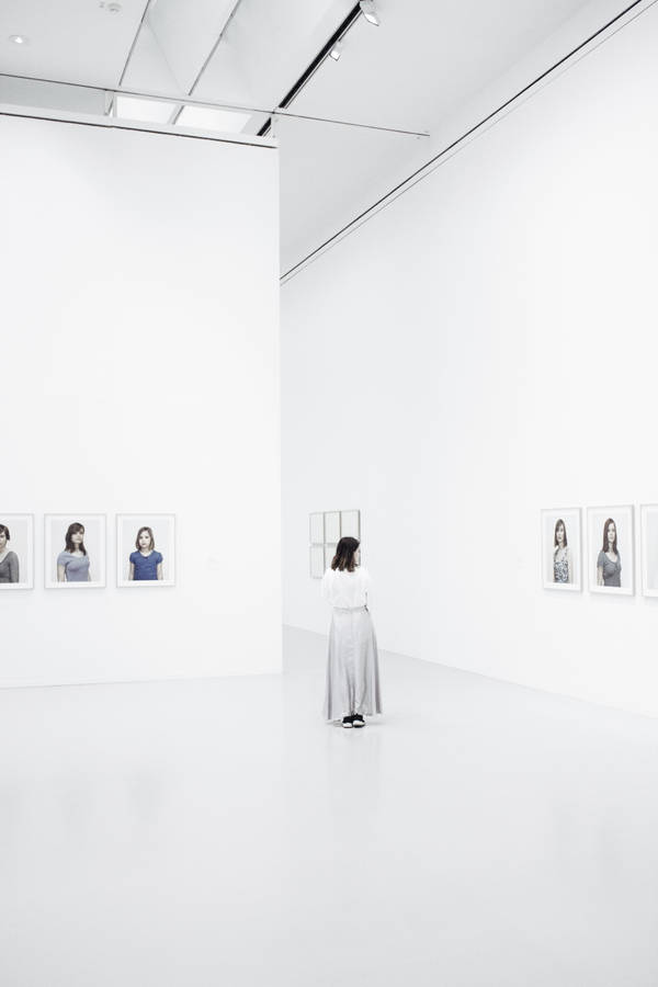 Woman Inside A Bright White Gallery Wallpaper