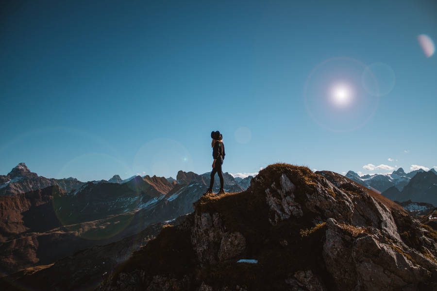 Woman Looking At Beautiful Blue Skies Wallpaper