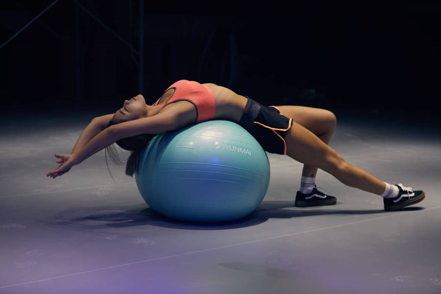 Woman On Fitness Stability Ball Wallpaper