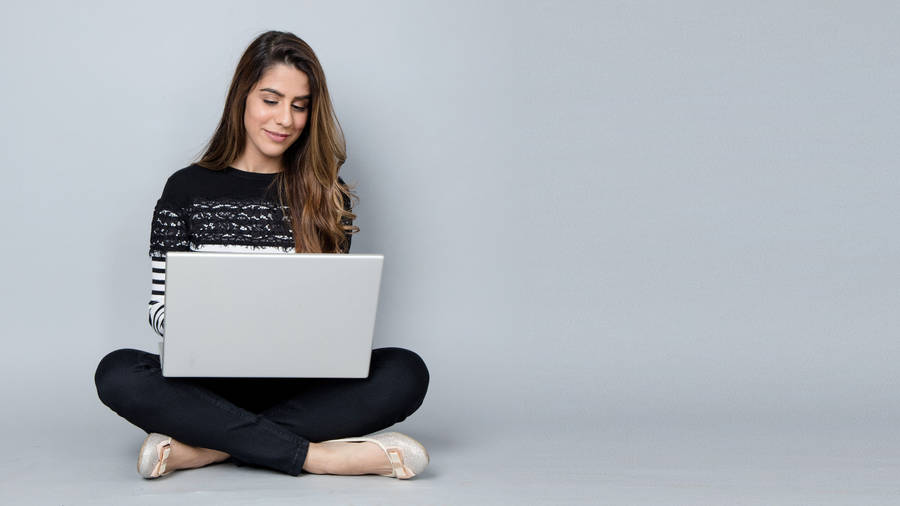 Woman Reading On Laptop Wallpaper