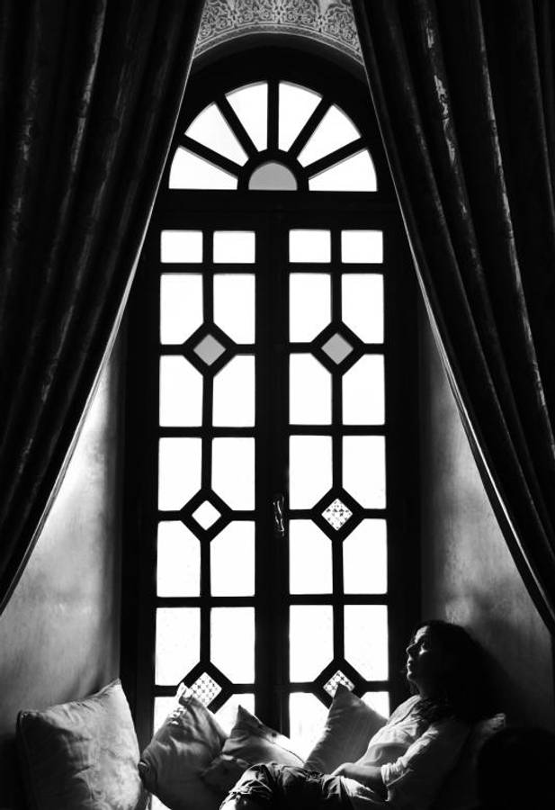 Woman Relaxing By The Window Wallpaper