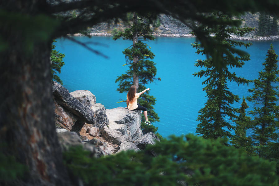 Woman Sitting Near Beautiful Blue Water Wallpaper