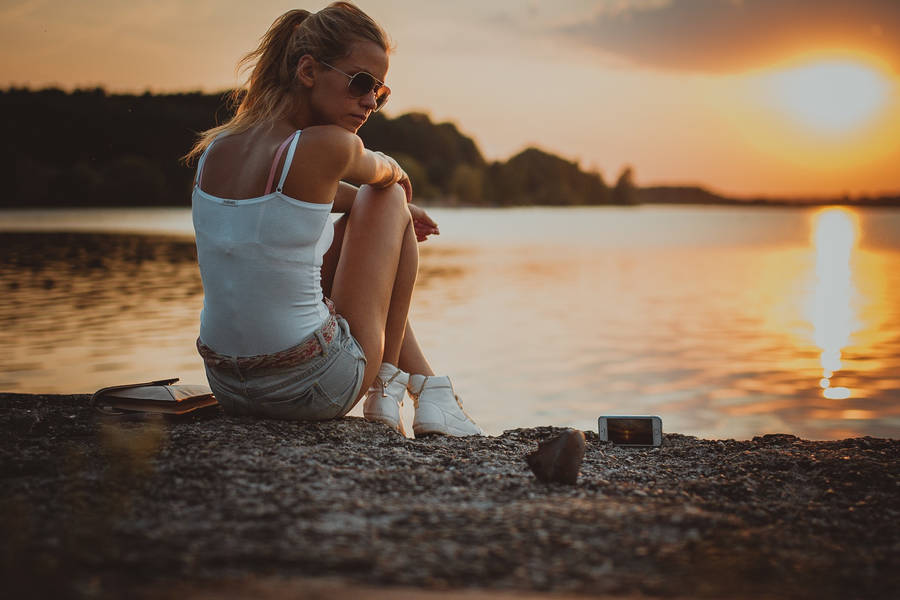 Woman Sitting On The Riverside Wallpaper