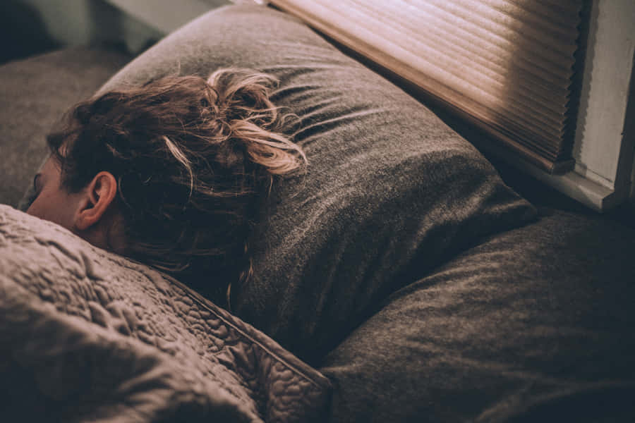 Woman Sleeping In A Dark Room Wallpaper