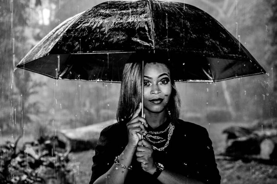 Woman Walking Outside While It's Raining Wallpaper