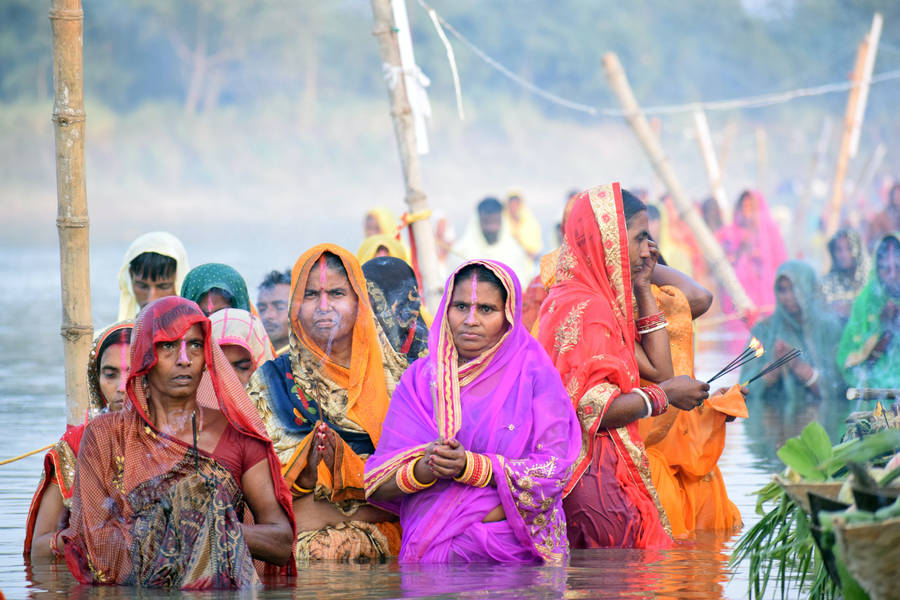 Women Celebrating Chhath Puja In Ocean Wallpaper