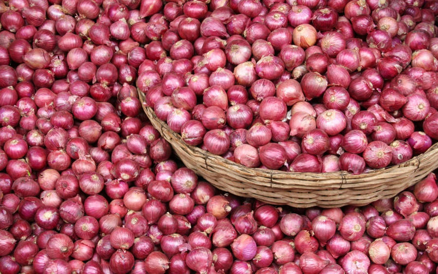 Wooden Basket Overflowing With Red Onions Wallpaper