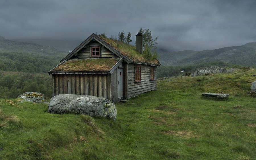 Wooden House Under A Cloudy Sky Wallpaper