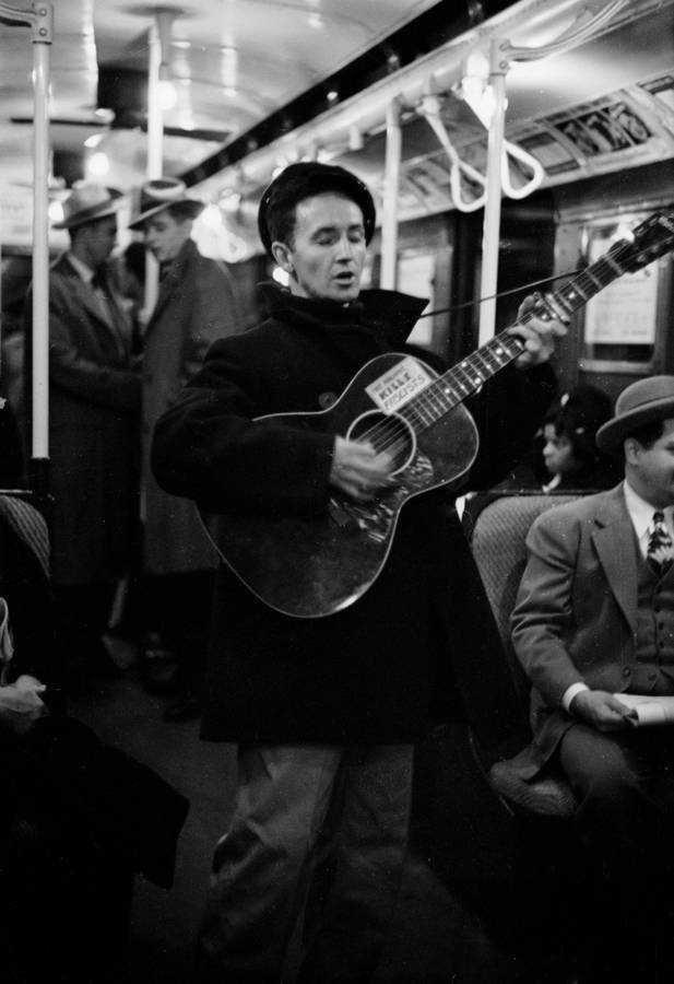 Woody Guthrie Playing Guitar In New York Subway Wallpaper