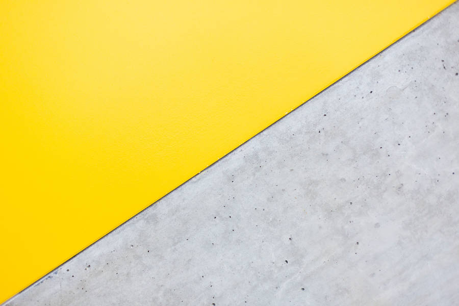 Working Behind A Bright Yellow Computer Reveals A Creative Mindset. Wallpaper