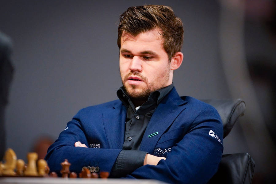 World Chess Champion Magnus Carlsen Deep In Thought Wallpaper