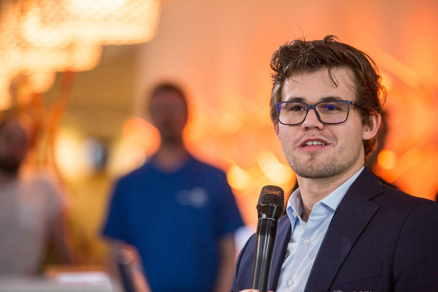 World Chess Champion Magnus Carlsen Speaking At An Event Wallpaper