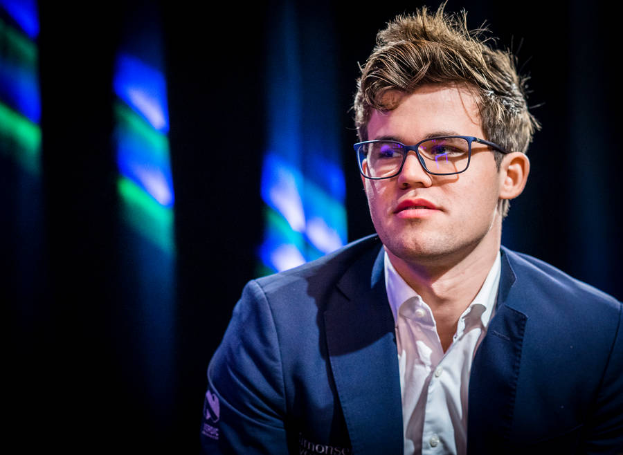 World Chess Champion Magnus Carlsen Sporting Spectacles Wallpaper