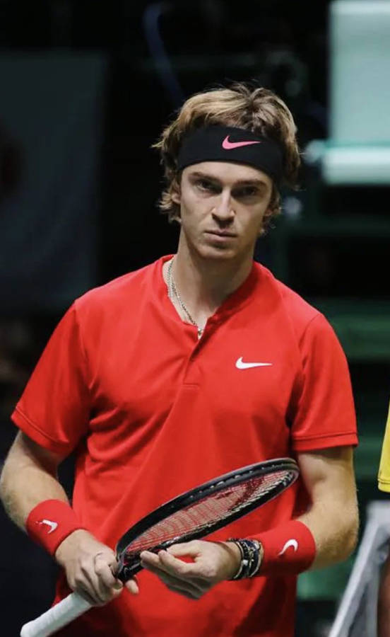 World-renowned Tennis Player, Andrey Rublev Holding A Tennis Racket Wallpaper