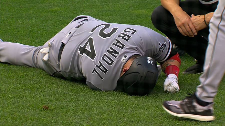 Yasmani Grandal Lying Down On Field Wallpaper