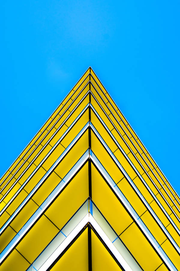 Yellow Triangle Building With Sharp Edges Wallpaper