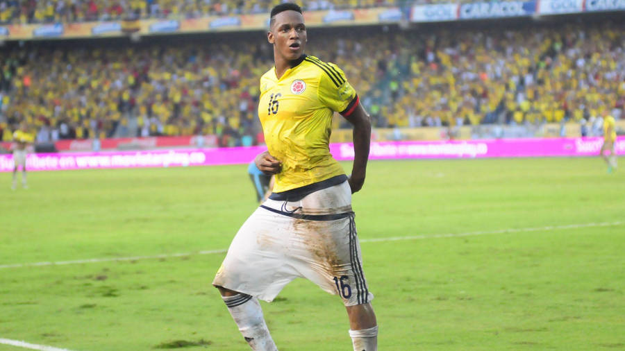 Yerry Mina In Yellow Jersey Wallpaper