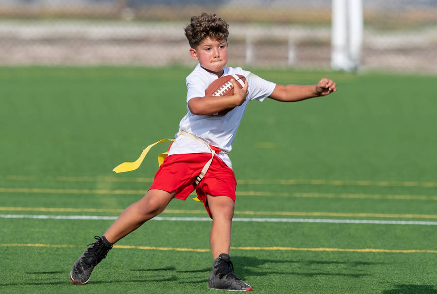 Young Boy At Youth Flag Football League Program Wallpaper