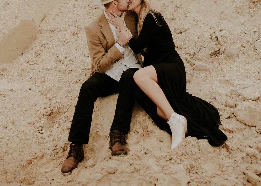 Young Couple In Love Admiring Sunset On A Beach Wallpaper