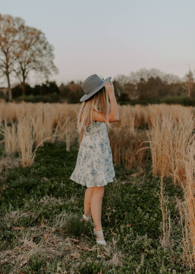 Young Lady In Field Enjoying Single Life Wallpaper