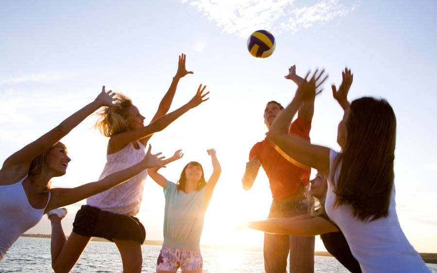 Young People Playing Beach Volleyball Wallpaper