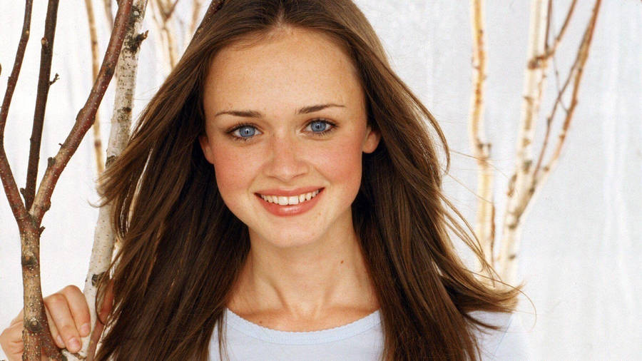 Young Rory Gilmore Smiling In Stars Hollow Wallpaper