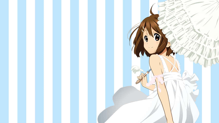 Yui Hirasawa Striking A Pose With Her Guitar On Stage Wallpaper