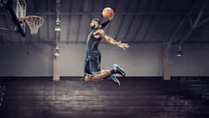A Basketball Player In Mid Air Dunks A Ball Wallpaper