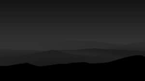 A Black And White Image Of A Mountain Range Wallpaper