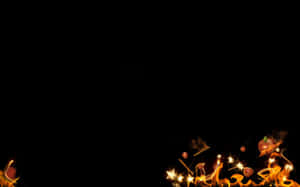 A Black Background With Fire And Flames Wallpaper
